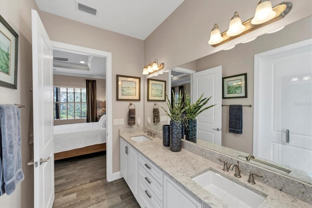 bathroom with hardwood / wood-style floors and vanity