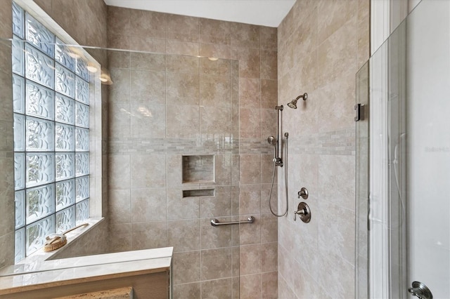 bathroom with tiled shower