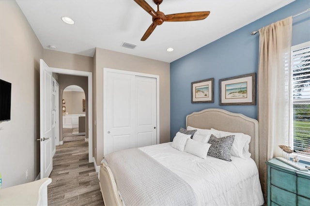 bedroom featuring ceiling fan, light wood-type flooring, and a closet