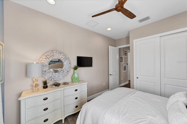 bedroom with ceiling fan, dark hardwood / wood-style floors, and a closet