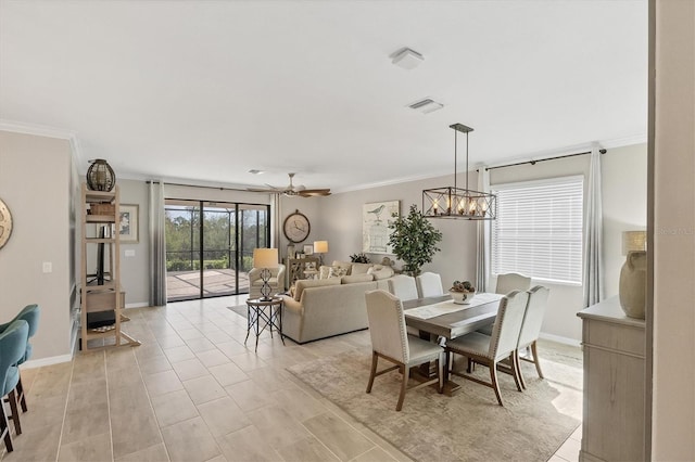 dining area featuring crown molding and ceiling fan with notable chandelier