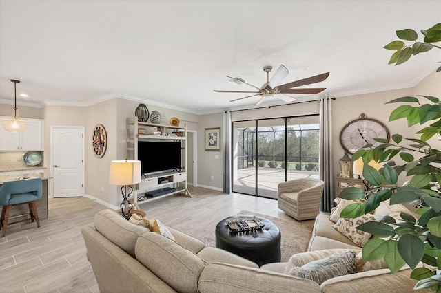 living room featuring light hardwood / wood-style floors, crown molding, and ceiling fan