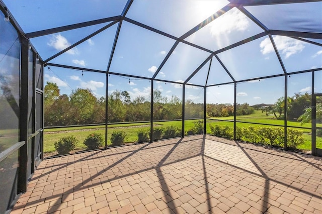 view of patio / terrace featuring glass enclosure