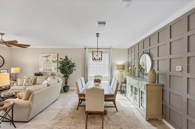 dining space featuring crown molding, a healthy amount of sunlight, and ceiling fan with notable chandelier