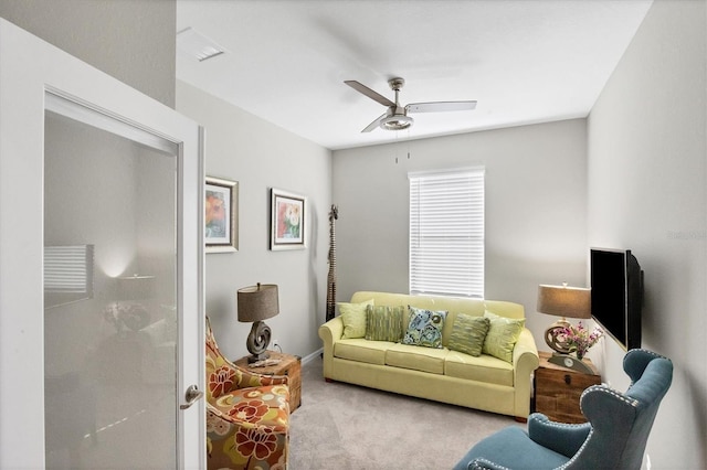 living room with light colored carpet and ceiling fan