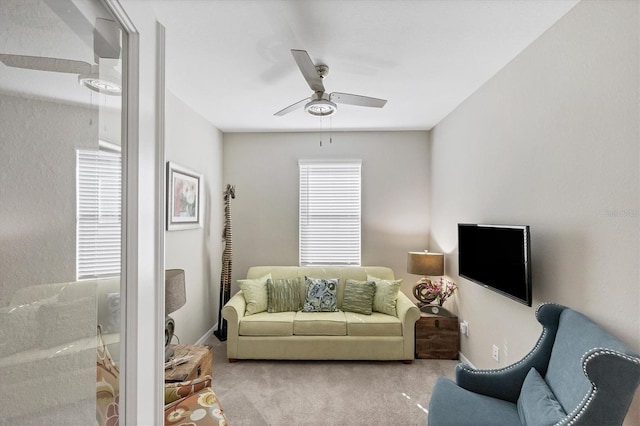 carpeted living room featuring ceiling fan