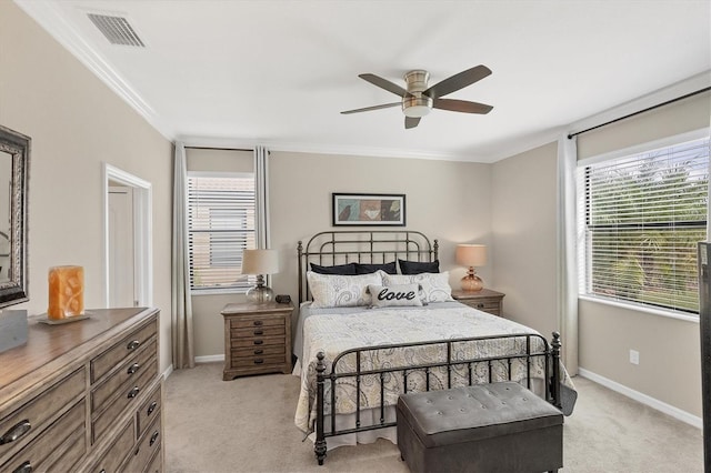 carpeted bedroom featuring ornamental molding and ceiling fan