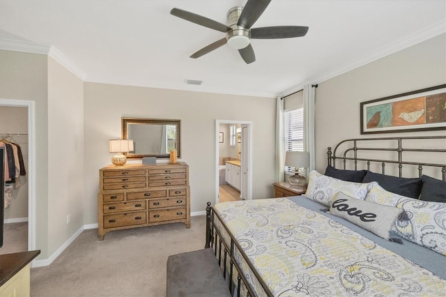 carpeted bedroom with ceiling fan, a spacious closet, crown molding, a closet, and ensuite bath