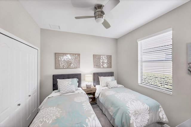 carpeted bedroom featuring a closet and ceiling fan