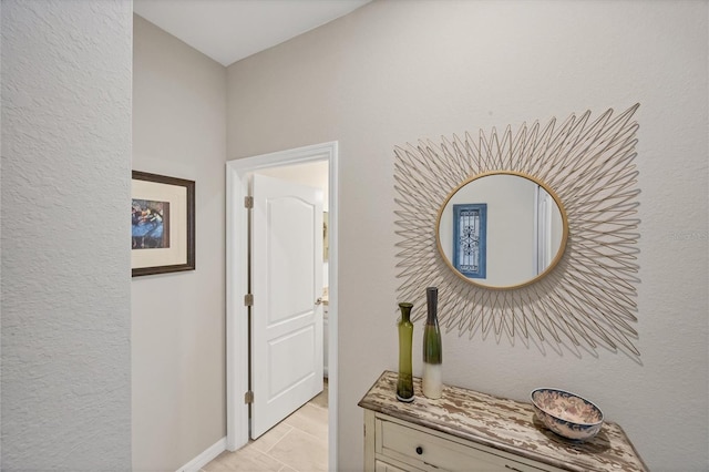 corridor featuring light tile patterned floors