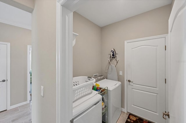 laundry room with light hardwood / wood-style flooring and separate washer and dryer