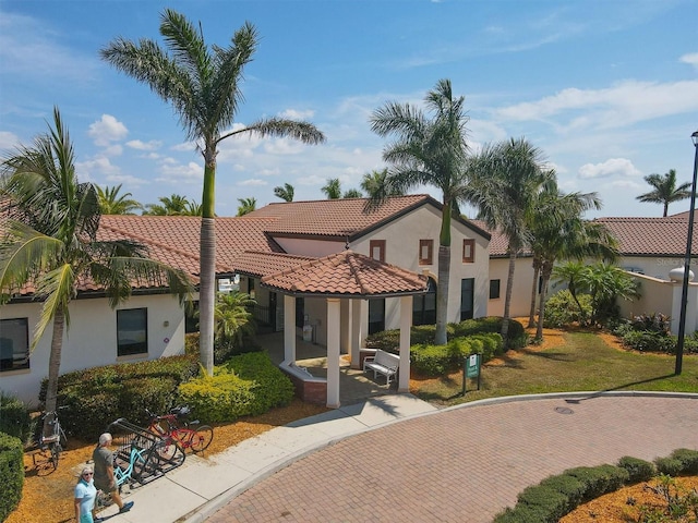 mediterranean / spanish-style home featuring a front lawn