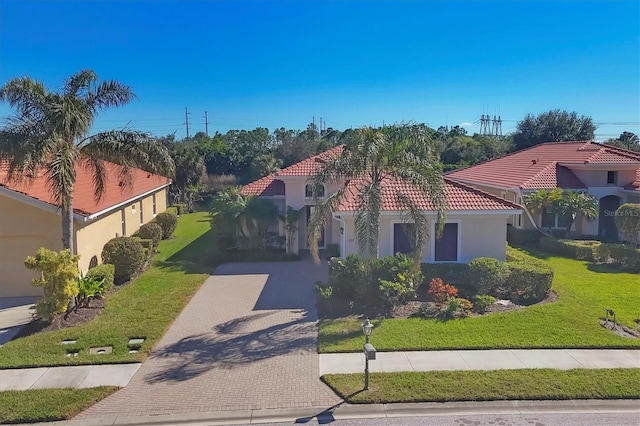 mediterranean / spanish house with a front lawn