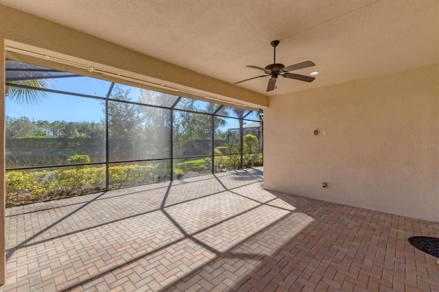 view of patio featuring a lanai and ceiling fan