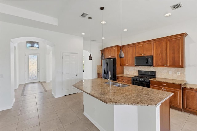 kitchen with pendant lighting, sink, light tile patterned floors, and black appliances