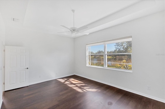 spare room featuring ceiling fan and dark wood-type flooring