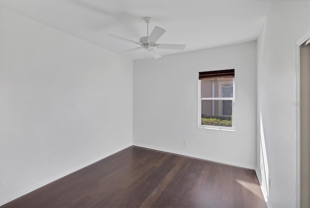 empty room featuring ceiling fan and dark hardwood / wood-style flooring