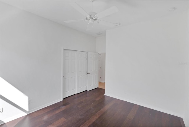 interior space with ceiling fan, a closet, and dark hardwood / wood-style floors