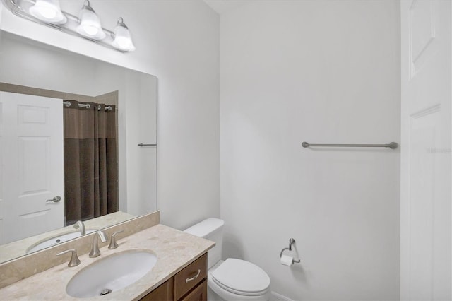 bathroom with vanity, toilet, and walk in shower