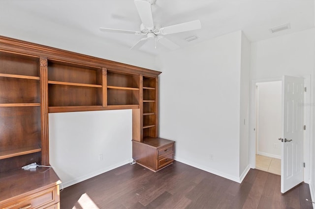 unfurnished office featuring ceiling fan and dark hardwood / wood-style flooring