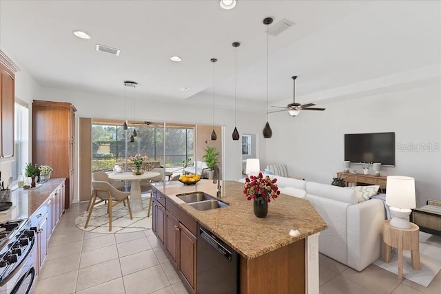 kitchen with stove, sink, decorative light fixtures, dishwasher, and an island with sink