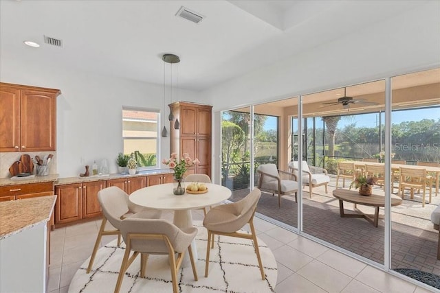 dining space featuring plenty of natural light, light tile patterned flooring, and ceiling fan