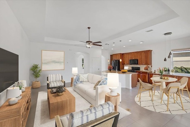 living room with ceiling fan and light tile patterned floors