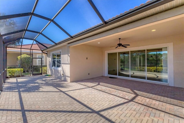 view of patio / terrace featuring glass enclosure and ceiling fan