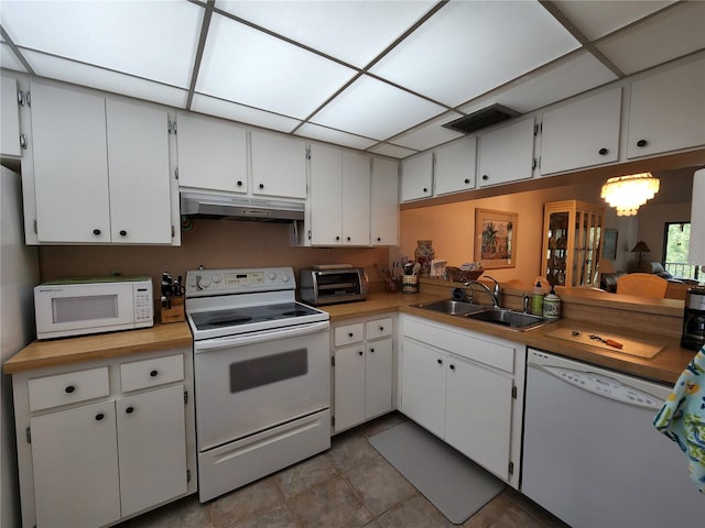 kitchen featuring white cabinets, sink, and white appliances