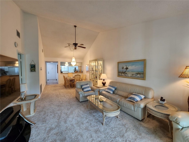 living room with carpet floors, high vaulted ceiling, and ceiling fan