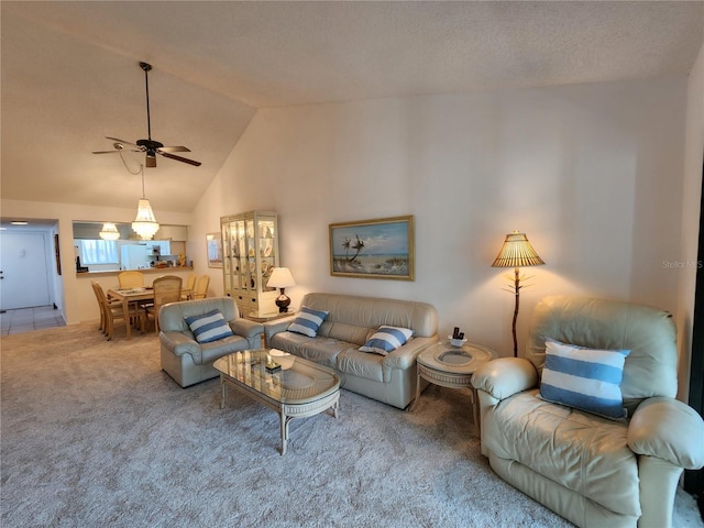 carpeted living room with high vaulted ceiling and ceiling fan