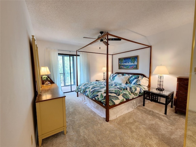 bedroom featuring access to outside, a textured ceiling, light colored carpet, and ceiling fan