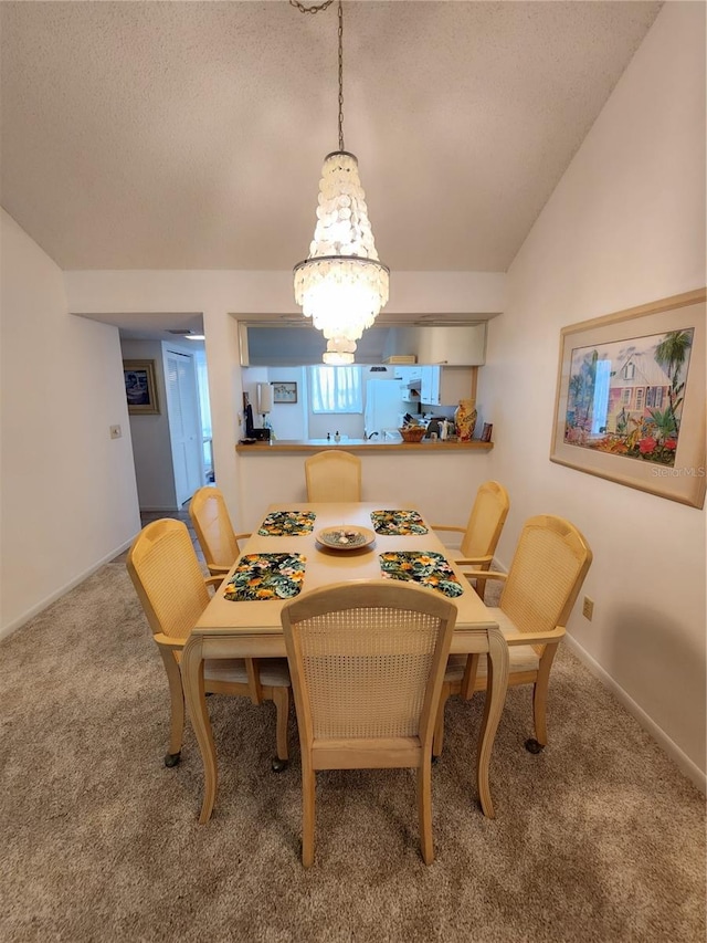 carpeted dining area with a textured ceiling, vaulted ceiling, and an inviting chandelier