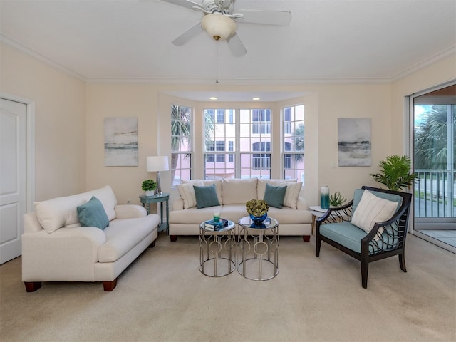 living room featuring crown molding, light colored carpet, and ceiling fan