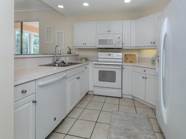 kitchen with a sink, recessed lighting, white appliances, and white cabinetry