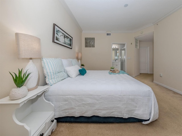 bedroom featuring connected bathroom, light carpet, and crown molding