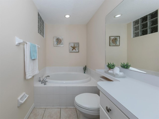 bathroom featuring vanity, tiled bath, tile patterned flooring, and toilet