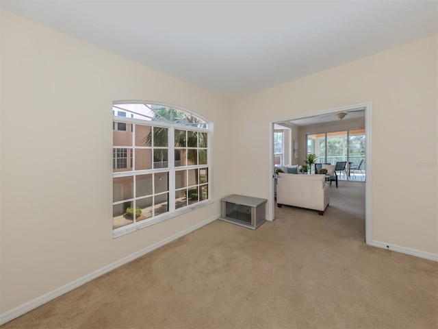 empty room with carpet flooring and baseboards