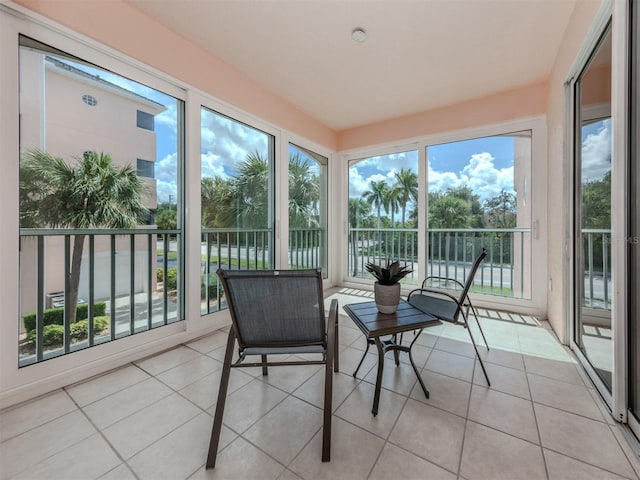 sunroom with a healthy amount of sunlight and tile patterned floors