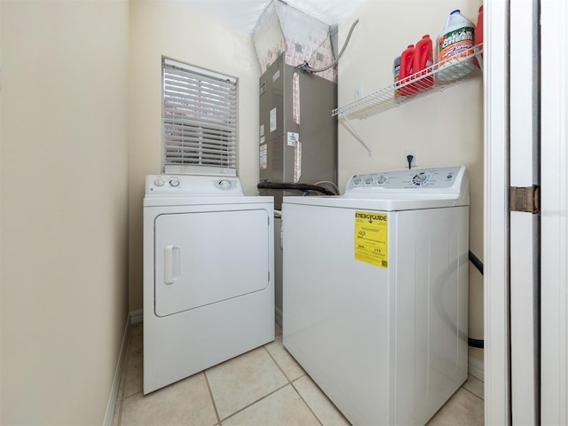washroom with separate washer and dryer, laundry area, and light tile patterned flooring
