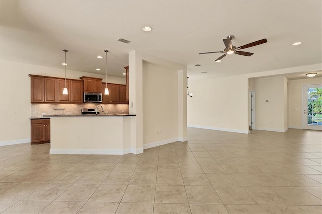 kitchen with ceiling fan, sink, decorative backsplash, hanging light fixtures, and light tile patterned floors