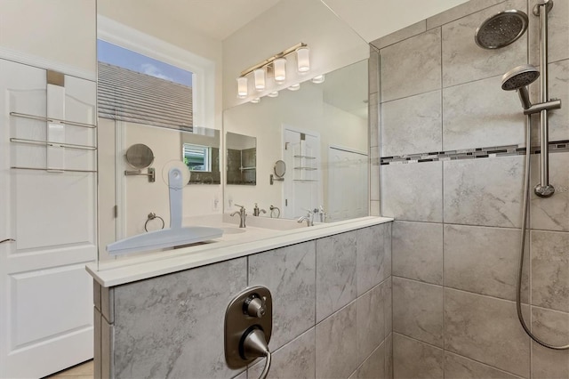 bathroom featuring vanity and tiled shower