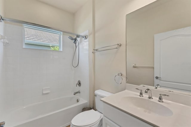 full bathroom featuring tiled shower / bath combo, vanity, and toilet