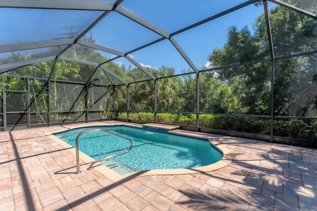 view of pool with a lanai, a patio, and pool water feature