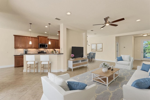 12273 Stuart Dr, Venice, FL 34293 - living room featuring recessed lighting, visible vents, light tile patterned flooring, baseboards, and ceiling fan