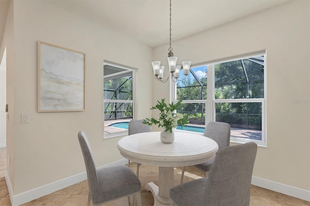 12273 Stuart Dr, Venice, FL 34293 - dining area with a wealth of natural light, baseboards, an inviting chandelier, and light tile patterned floors
