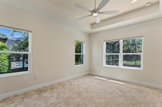 12273 Stuart Dr, Venice, FL 34293 - spare room with a ceiling fan, baseboards, carpet, and a raised ceiling