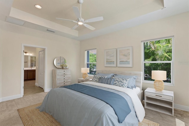 12273 Stuart Dr, Venice, FL 34293 - bedroom with light colored carpet, baseboards, visible vents, and a raised ceiling