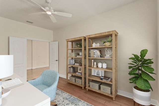 12273 Stuart Dr, Venice, FL 34293 - office area featuring wood finished floors, baseboards, a ceiling fan, and visible vents