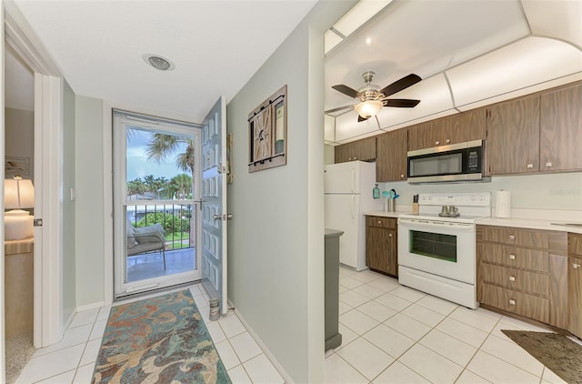 kitchen with ceiling fan, light tile patterned floors, and white appliances